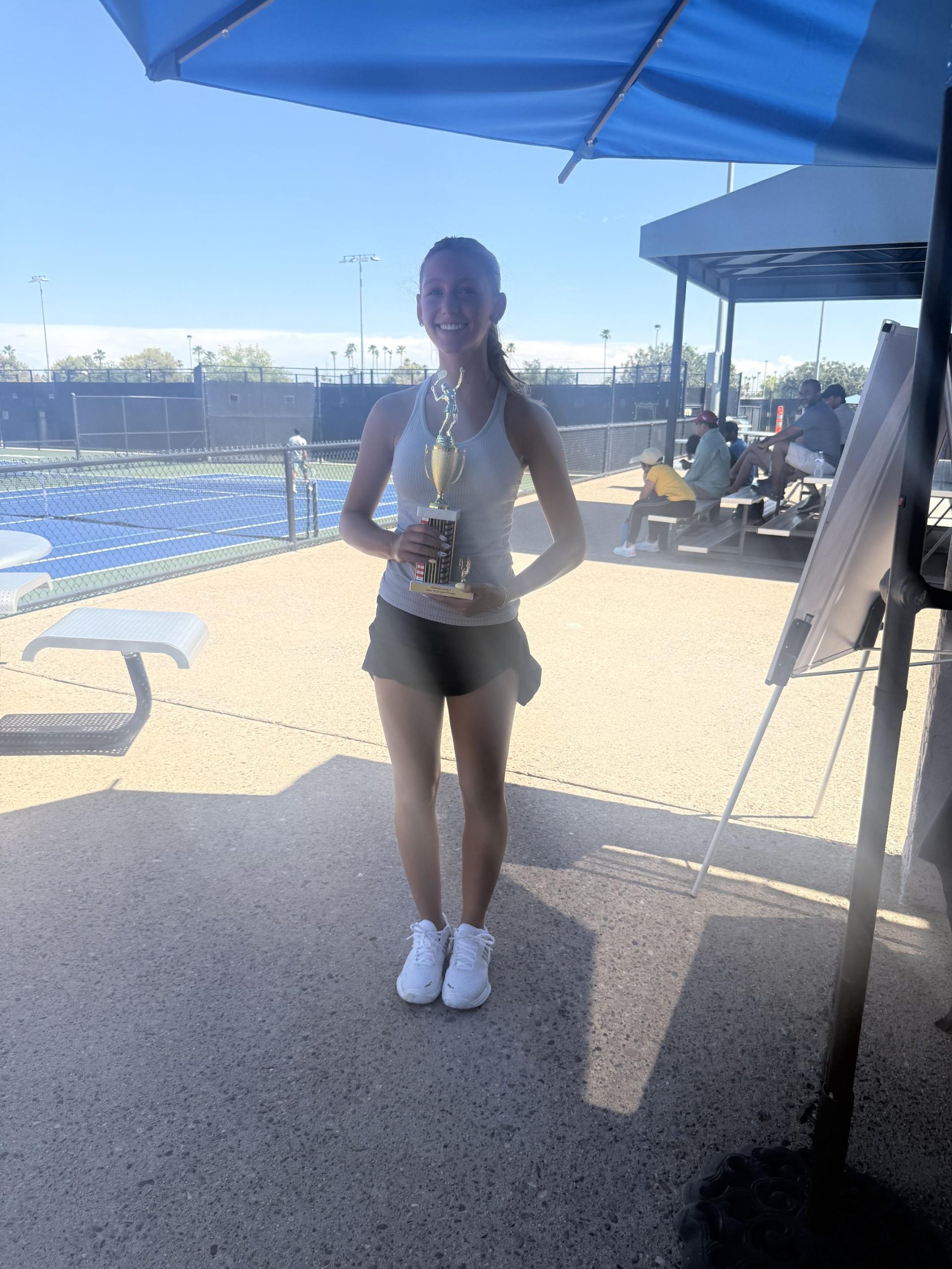 UPTA student with tournament trophy